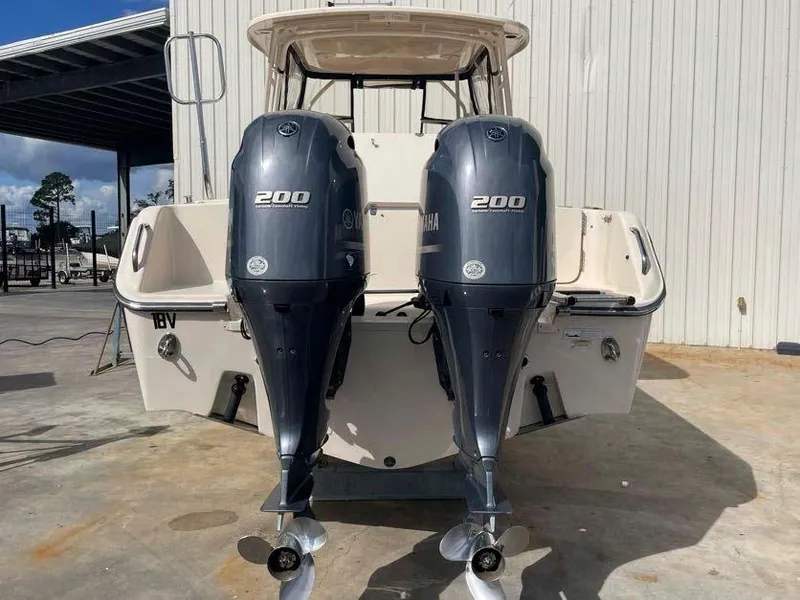 Slide: The Image of 2015 Grady-White Freedom 275 boat with twin Yamaha 200 engines, docked outdoors. - 24