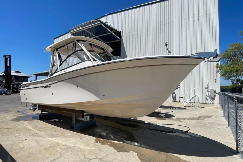 Slide: The Image of 2015 Grady-White Freedom 275 boat on display outside a large building. - 5