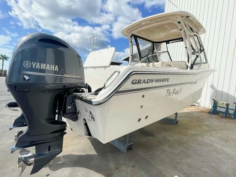 Slide: The Image of 2015 Grady-White Freedom 275 boat with Yamaha engine, docked outdoors. - 6