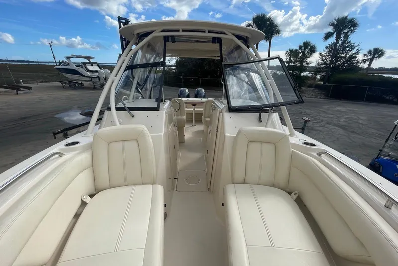 Slide: The Image of 2015 Grady-White Freedom 275 boat interior with seating, windshield, and open deck view. - 8