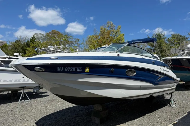 The Image of 2019 Crownline Eclipse E235 XS boat on display under a clear blue sky. - 1