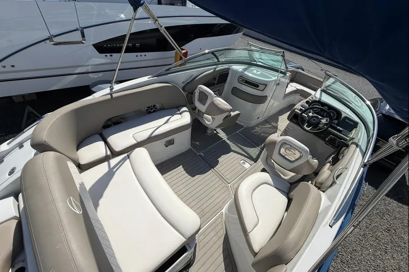 Slide: The Image of 2019 Crownline Eclipse E235 XS boat interior with plush seating and modern dashboard. - 12