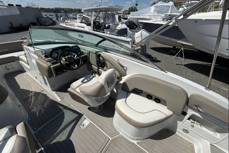 Slide: The Image of 2019 Crownline Eclipse E235 XS boat interior with steering wheel and seating area. - 22