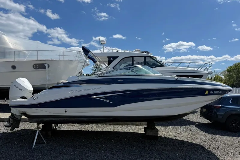 Slide: The Image of 2019 Crownline Eclipse E235 XS boat on display under a clear blue sky. - 6