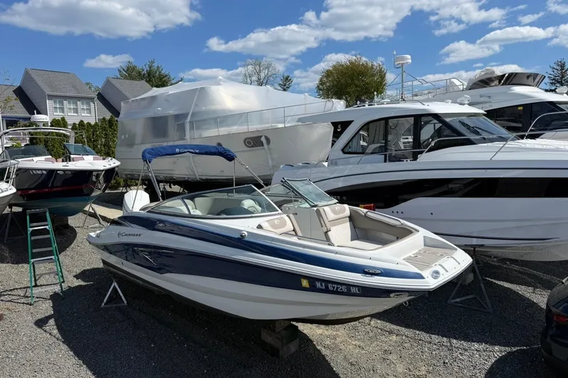 Slide: The Image of 2019 Crownline Eclipse E235 XS boat displayed outdoors with other vessels. - 9