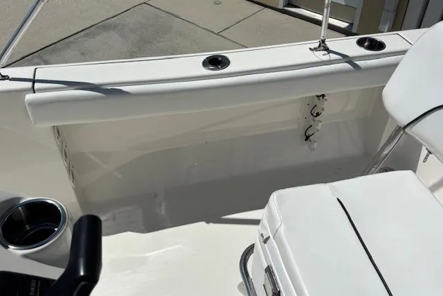 Slide: The Image of 2013 Key West 189 FS boat interior with white seating and cup holders. - 11