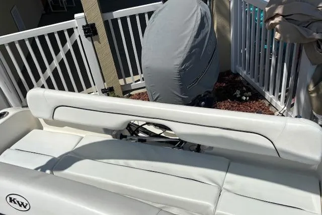 Slide: The Image of 2013 Key West 189 FS boat interior with white seating and covered motor. - 18