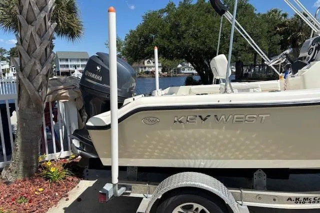 Slide: The Image of 2013 Key West 189 FS boat on trailer, parked near waterfront with Yamaha engine. - 4