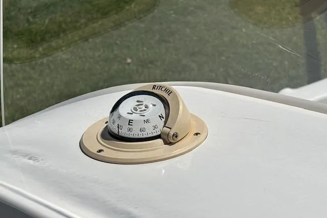 Slide: The Image of Ritchie compass on 2013 Key West 189 FS boat dashboard, close-up view. - 8