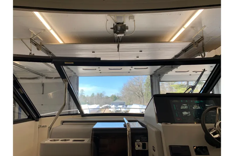 Slide: The Image of Interior view of 2024 Regal 36 Grande Coupe boat in a garage setting. - 13