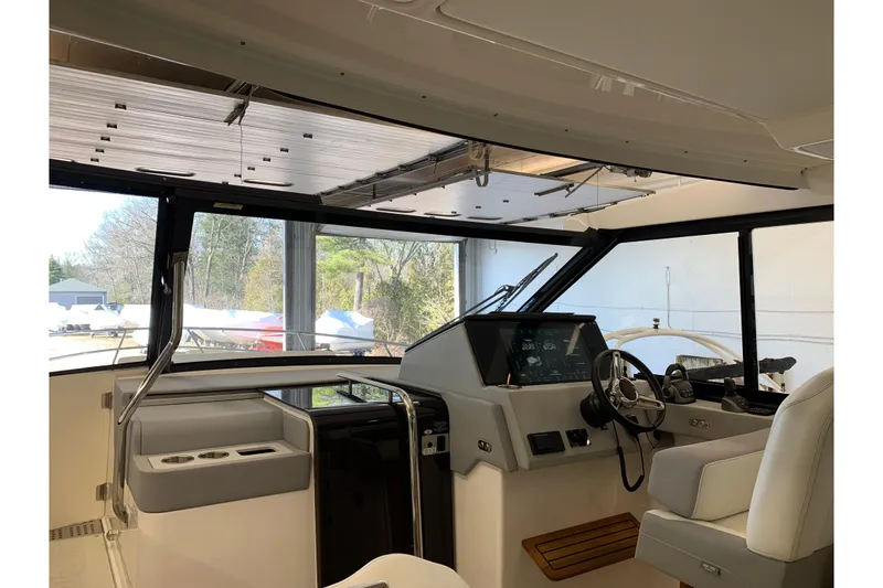 Slide: The Image of Interior view of 2024 Regal 36 Grande Coupe yacht cockpit with modern controls. - 14
