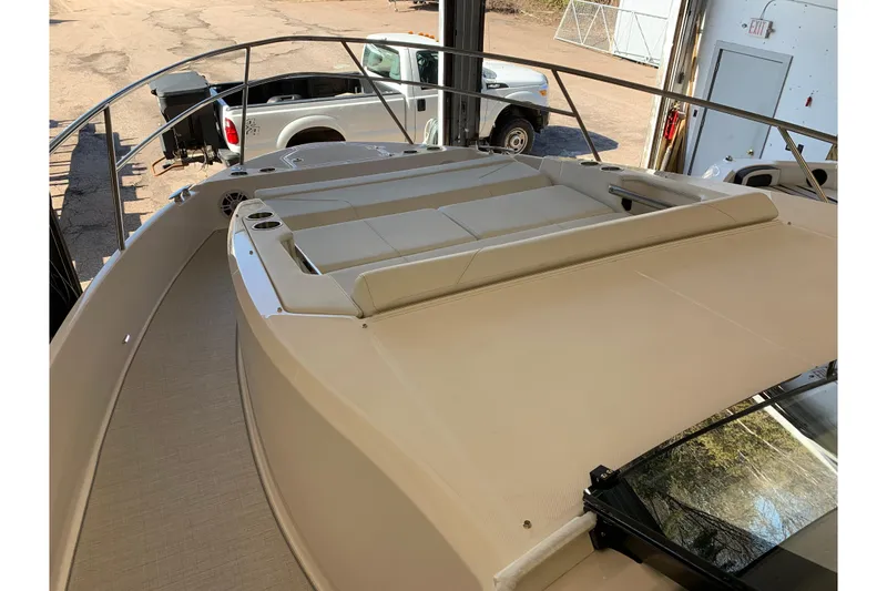 Slide: The Image of 2024 Regal 36 Grande Coupe boat deck with seating area, parked in a garage. - 15