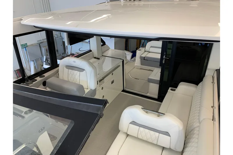 Slide: The Image of 2024 Regal 36 Grande Coupe interior with luxurious white seating and modern design. - 16