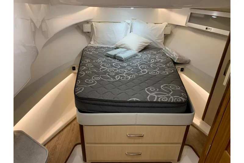 Slide: The Image of 2024 Regal 36 Grande Coupe cabin interior with cozy bed and modern design. - 19