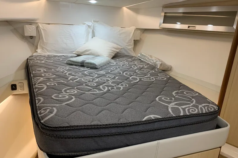 Slide: The Image of Luxurious cabin interior of 2024 Regal 36 Grande Coupe with elegant bedding. - 20