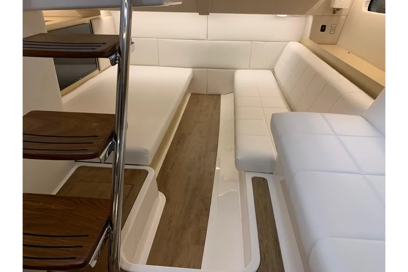 Slide: The Image of Interior of 2024 Regal 36 Grande Coupe with white seating and wooden steps. - 23