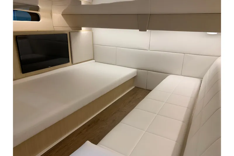 Slide: The Image of 2024 Regal 36 Grande Coupe interior cabin with modern seating and TV. - 24