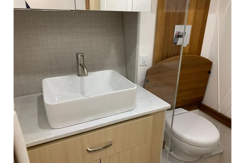 Slide: The Image of 2024 Regal 36 Grande Coupe bathroom with modern sink and toilet design. - 25