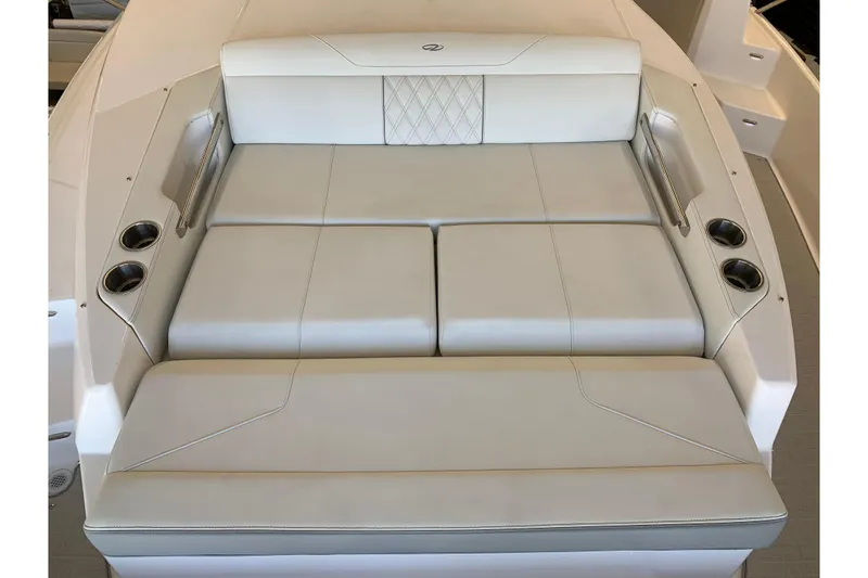 Slide: The Image of 2024 Regal 36 Grande Coupe boat seating area with cup holders and elegant upholstery. - 27