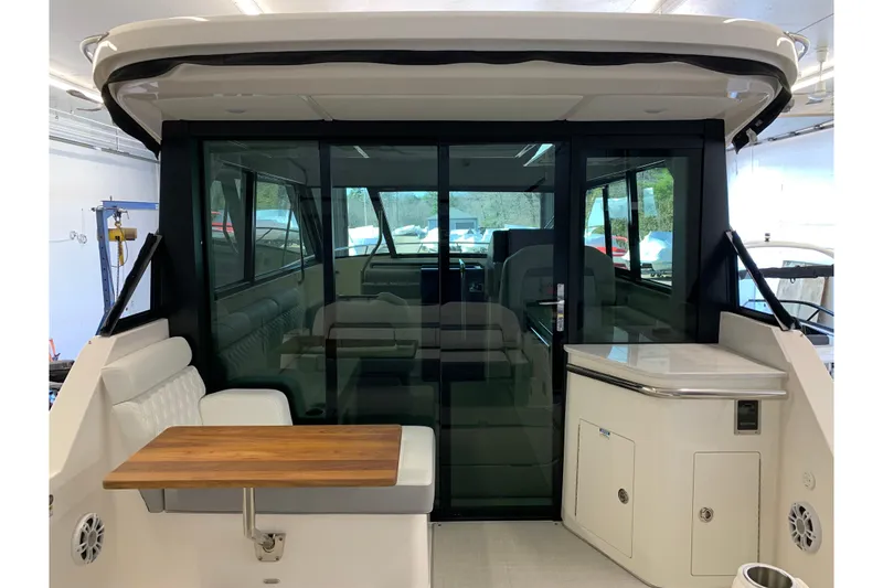 Slide: The Image of 2024 Regal 36 Grande Coupe interior with seating and table in a modern design. - 30
