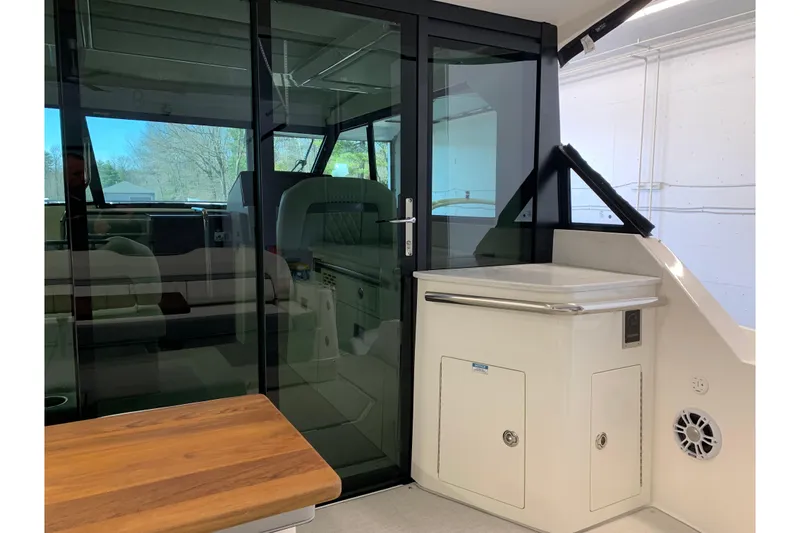 Slide: The Image of 2024 Regal 36 Grande Coupe interior with sleek glass doors and modern seating. - 31