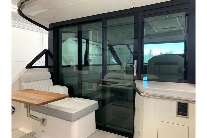Slide: The Image of 2024 Regal 36 Grande Coupe interior with sliding glass doors and seating area. - 33