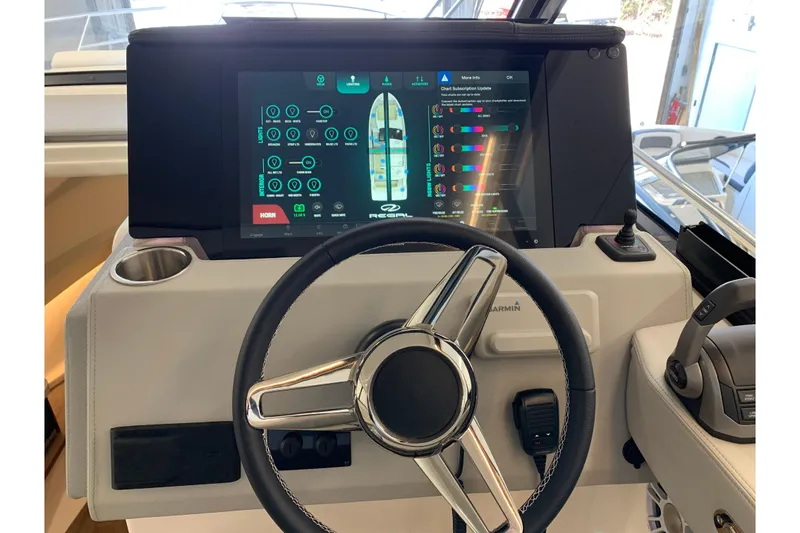 Slide: The Image of 2024 Regal 36 Grande Coupe helm with touchscreen display and steering wheel. - 4