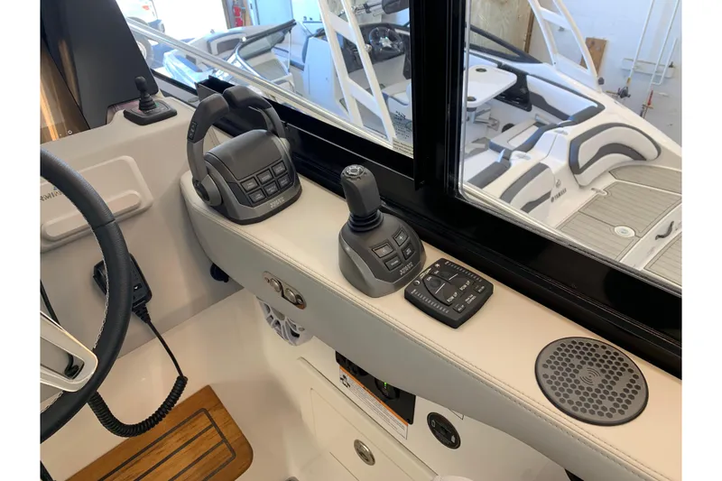 Slide: The Image of 2024 Regal 36 Grande Coupe helm controls with joystick and throttle levers. - 5