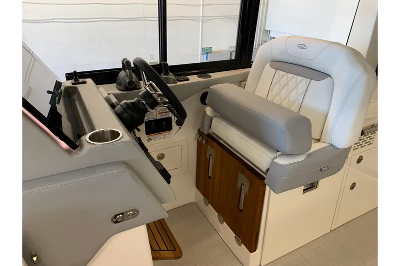 Slide: The Image of 2024 Regal 36 Grande Coupe helm with luxurious seating and modern controls. - 6