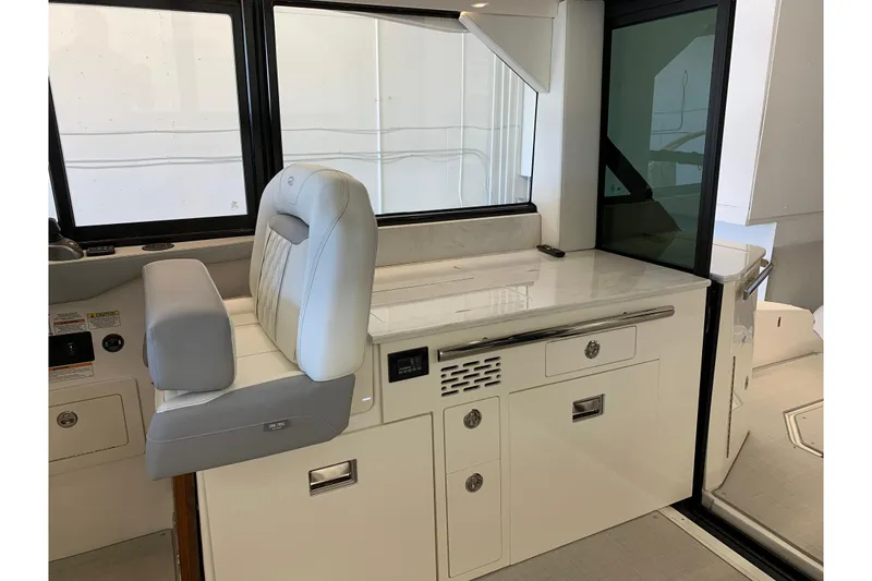 Slide: The Image of 2024 Regal 36 Grande Coupe interior with sleek white cabinetry and modern seating. - 7