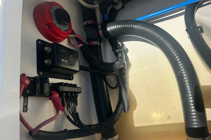 Slide: The Image of Electrical components and wiring inside a 2007 Boston Whaler 200 Dauntless boat. - 13