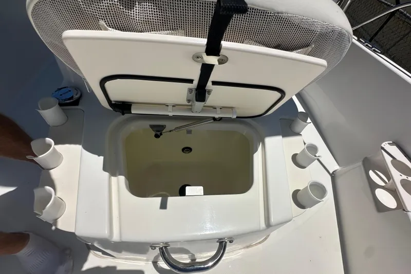 Slide: The Image of Open storage compartment on 2007 Boston Whaler 200 Dauntless boat with rod holders. - 14