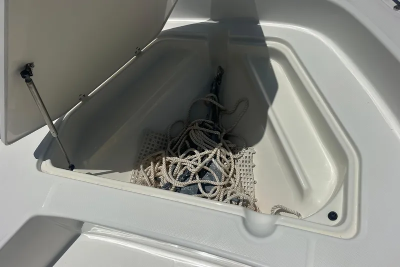 Slide: The Image of Open storage compartment on a 2007 Boston Whaler 200 Dauntless boat with coiled rope. - 15