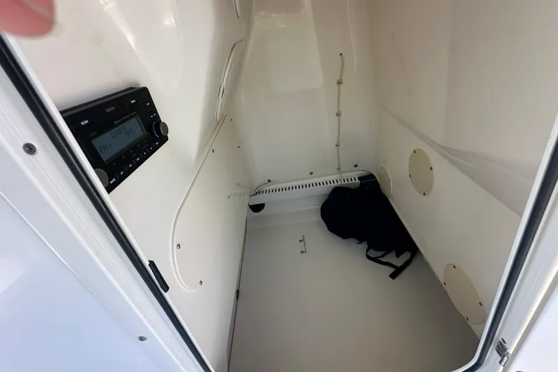 Slide: The Image of Interior cabin of a 2007 Boston Whaler 200 Dauntless with radio and storage space. - 17