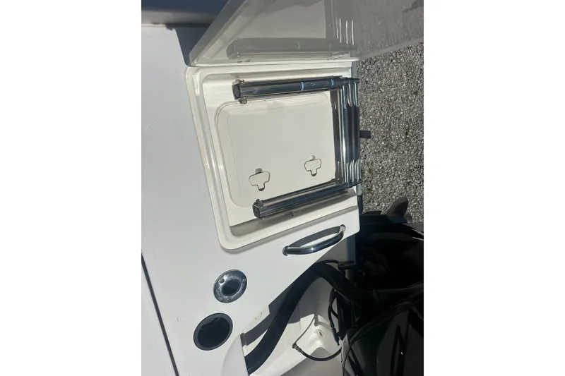 Slide: The Image of 2007 Boston Whaler 200 Dauntless boat ladder and storage compartment detail. - 19