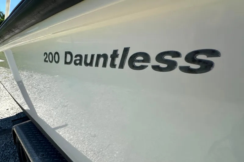 Slide: The Image of 2007 Boston Whaler 200 Dauntless boat side view with model name visible. - 4