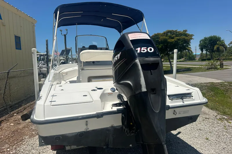 Slide: The Image of 2007 Boston Whaler 200 Dauntless boat with Mercury 150 engine, parked outdoors. - 5
