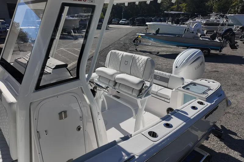 Slide: The Image of 2026 Sea Fox 228 Commander boat interior with seating and Yamaha engine in a marina setting. - 10