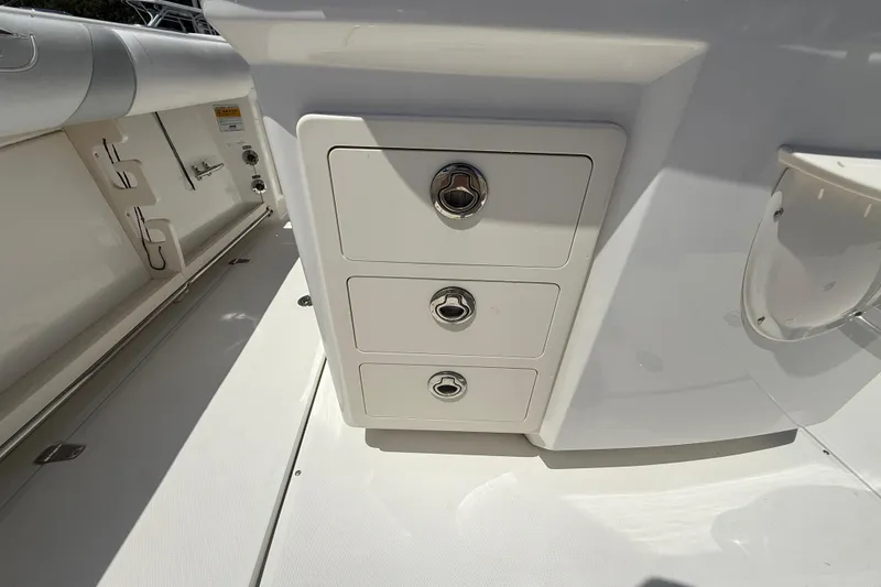 Slide: The Image of Storage drawers on a 2014 Boston Whaler 250 Outrage boat interior. - 10