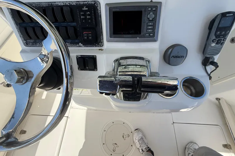 Slide: The Image of Control panel of a 2014 Boston Whaler 250 Outrage boat with steering wheel and electronics. - 14