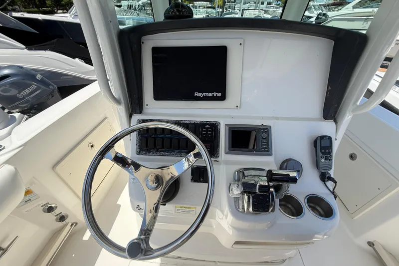 Slide: The Image of 2014 Boston Whaler 250 Outrage helm with Raymarine display and steering wheel. - 17
