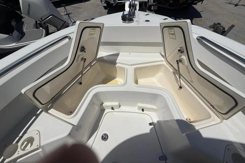 Slide: The Image of 2014 Boston Whaler 250 Outrage boat with open storage compartments on deck. - 19