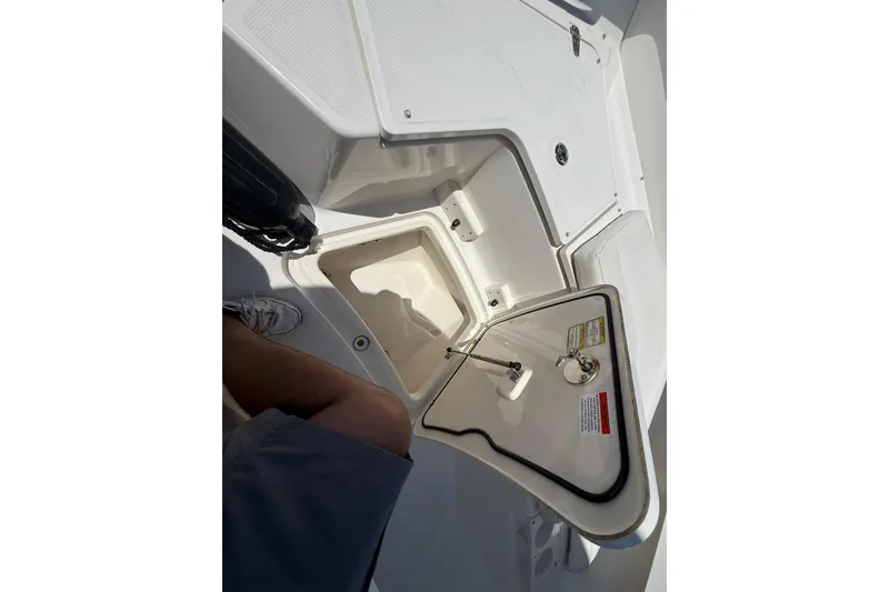Slide: The Image of Open storage compartment on a 2014 Boston Whaler 250 Outrage boat. - 21