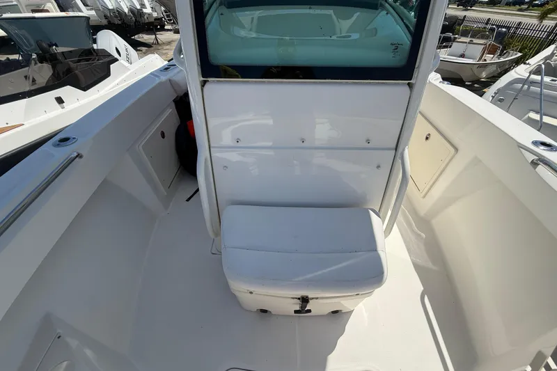 Slide: The Image of 2014 Boston Whaler 250 Outrage boat interior with seating and storage. - 22