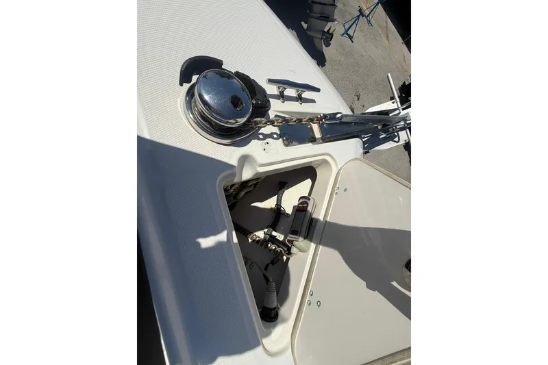 Slide: The Image of 2014 Boston Whaler 250 Outrage anchor compartment with winch and chain. - 24