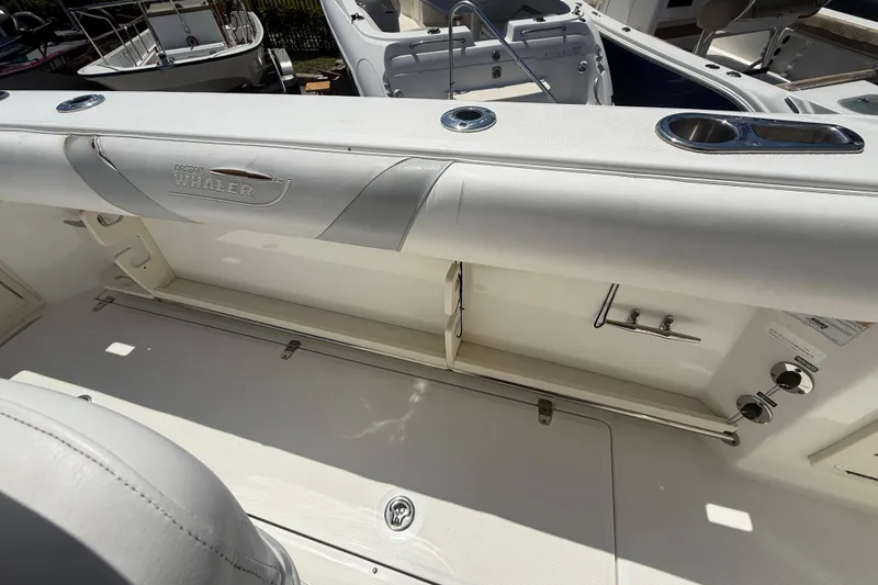 Slide: The Image of 2014 Boston Whaler 250 Outrage boat interior with seating and storage features. - 25