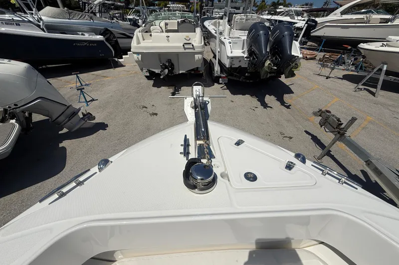 Slide: The Image of 2014 Boston Whaler 250 Outrage boat in marina, surrounded by other vessels. - 26