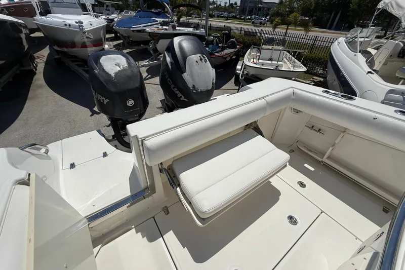 Slide: The Image of 2014 Boston Whaler 250 Outrage boat with Mercury engines, docked in a marina. - 8