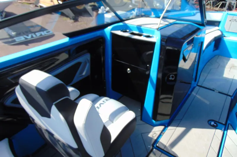 Slide: The Image of Interior of 2022 Yamaha Boats 255XD, featuring sleek blue and black design with comfortable seating. - 11