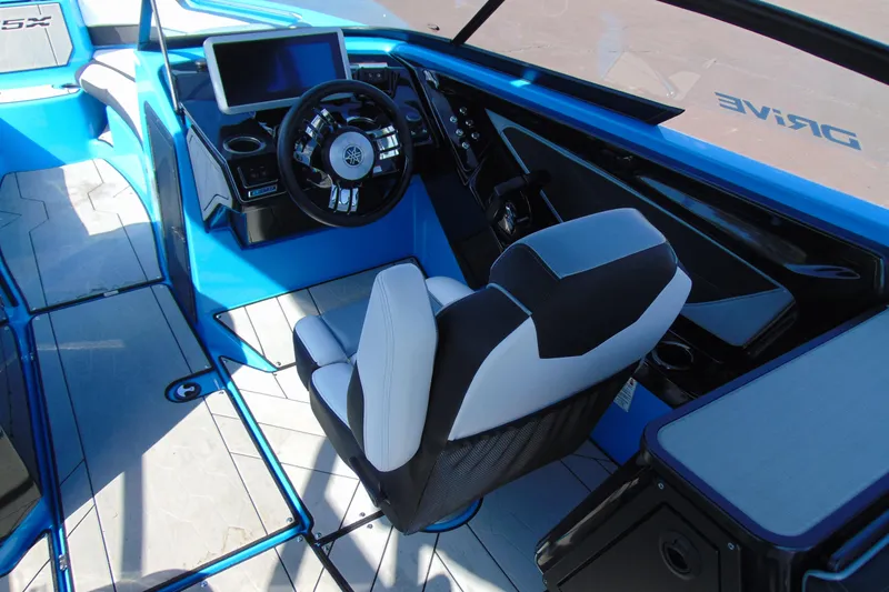 Slide: The Image of 2022 Yamaha Boats 255XD interior with modern steering and seating design. - 12